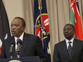 Kenya's President Uhuru Kenyatta, left, accompanied by Deputy President William Ruto, right, speaks to the media at State House in Nairobi, Kenya Thursday, Sept. 21, 2017. Kenya's electoral commission has announced it has moved the date for a fresh presidential election to Oct 26. The electoral commission had earlier set Oct 17 as the date for the fresh poll after the Supreme Court invalidated President Uhuru Kenyatta's August re-election and ordered a rerun within 60 days. (AP Photo/Khalil Senosi)