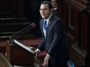 FILE - In this Jan. 14, 2017 file photo, Guatemala's President Jimmy Morales delivers his first annual State of the Nation address to Congress in Guatemala City. A five-member commission of legislators has recommended lifting Morales' immunity from prosecution so he can face possible trial on campaign-financing accusations. Commission head Julio Ixcamey said late Sept. 10, 2017 the recommendation will be submitted to the full congress for a vote. (AP Photo/Moises Castillo, File)