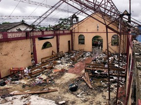 FILE - This May 8, 2002 file photo shows a destroyed church in Bojaya, in Colombia's northwestern state of Choco. The church was destroyed on May 2, 2002, when rebels of the Revolutionary Armed Forces of Colombia (FARC) fired homemade missiles during fighting with paramilitaries killing more than a hundred civilians, mostly women and children. A study by Colombia's Bishops Conference found that at least 40 Catholic priests were killed by terrorist groups between 1987 and 2003. More than 63 churches had been damaged or destroyed. (AP Photo/Ricardo Mazalan, File)