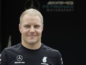 Mercedes driver Valtteri Bottas of Finland walks in the paddock, at the Monza racetrack, in Monza, Italy, Thursday, Aug.31, 2017. The Formula one race will be held on Sunday. (AP Photo/Luca Bruno)