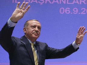Turkey's President Recep Tayyip Erdogan waves prior to his speech at local leaders of his ruling party in Ankara, Turkey, Wednesday, Sept. 6, 2017. Erdogan renewed his call on the European Union to make its up mind on whether it wants to continue or end membership talks with his country, angered by a political debate in Germany that centered on how to deal with Turkey. (Presidency Press Service via AP, Pool)