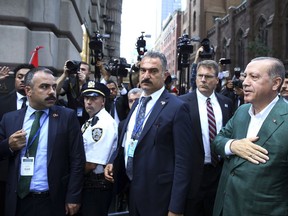 In this Sunday, Sept. 17, 2017 photo made available Monday, Sept 18, 2017, Turkey's President Recep Tayyip Erdogan, right, acknowledges supporters as he arrives at his hotel in New York. Erdogan is in New York for the United Nations General Assembly. (Presidency Press Service, Pool Photo via AP)