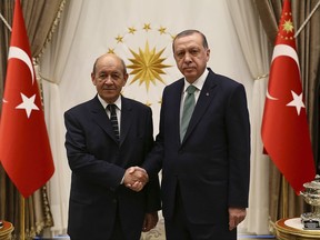 Turkey's President Recep Tayyip Erdogan, right, shakes hands with France's Foreign Minister Jean-Yves Le Drian left, prior to their meeting at the Presidential Palace in Ankara, Turkey, Thursday, Sept. 14, 2017. (Pool Photo via AP)