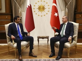 Turkey's President Recep Tayyip Erdogan, right, talks with Qatar's Emir Sheikh Tamim bin Hamad Al Thani, left, prior to their meeting at the Presidential Palace in Ankara, Turkey, Thursday, Sept. 14, 2017. Turkey said it wants Qatar and its Arab neighbours to overcome differences through dialogue and a "brotherly" manner as Al Thani was in Ankara on his first foreign trip since a diplomatic crisis erupted. (Pool Photo via AP)