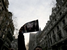 A demonstrator holds a photo of missing activist Santiago Maldonado, during a protest at Plaza de Mayo in Buenos Aires, Argentina, Friday, Sept. 1, 2017. Human rights groups say Maldonado went missing a month ago today, after Argentine border police captured him during an operation against Mapuche Indians who were blocking a highway in Argentina's Patagonia. (AP Photo/Natacha Pisarenko)