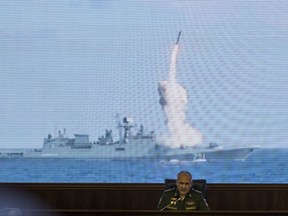 Col. Gen. Sergei Rudskoi of the Russian General Staff attends a briefing in the Russian Defense Ministry in Moscow, Russia, Wednesday, Sept. 6, 2017, backdropped by a screen showing a Russian navy's Admiral Essen frigate launching a cruise missile at the Islamic state in Syria. The commander of the Russian forces in Syria Sergei Surovikin says Russian jets have carried out more than 2,600 airstrikes in the past two weeks to support the government's efforts to drive Islamic State militants from an eastern city. (AP Photo/Pavel Golovkin)