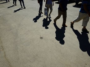 Migrants from Syria walk towards a refugee camp at Kokkinotrimithia, outside of the capital Nicosia, in the eastern Mediterranean island of Cyprus, on Sunday, Sept. 10, 2017. Cyprus police say a 36-year-old man was arrested Sunday for allegedly driving one of a pair of boats that brought 305 Syrian refugees to the island's northwestern coast. (AP Photo/Petros Karadjias)