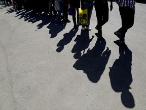 Migrants from Syria walk towards a refugee camp at Kokkinotrimithia, outside the capital Nicosia, in the eastern Mediterranean island of Cyprus, on Sunday, Sept. 10, 2017. Cyprus police say a 36-year-old man has been arrested for allegedly driving one of a pair of boats that brought 305 Syrian refugees to the island's northwestern coast. The migrants they departed from Mersin, Turkey on Saturday late. (AP Photo/Petros Karadjias)