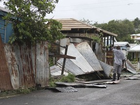 A man surveys the wreckage on his property after the passing of Hurricane Irma, in St. John's, Antigua and Barbuda, Wednesday, Sept. 6, 2017. Heavy rain and 185-mph winds lashed the Virgin Islands and Puerto Rico's northeast coast as Irma, the strongest Atlantic Ocean hurricane ever measured, roared through Caribbean islands on its way to a possible hit on South Florida. (AP Photo/Johnny Jno-Baptiste)