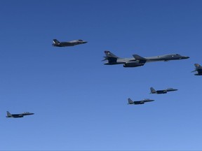 In this photo provided by South Korea Defense Ministry, U.S. Air Force B-1B bombers, F-35B stealth fighter jets and South Korean F-15K fighter jets fly over the Korean Peninsula during a joint drills, South Korea Monday, Sept. 18, 2017. South Korea says the U.S. military has flown powerful bombers and stealth jets over the Korean Peninsula in joint drills with South Korean warplanes.