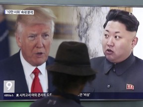 In this Aug. 10, 2017, file photo, a man watches a TV screen showing U.S. President Donald Trump, left, and North Korean leader Kim Jong Un during a news program at the Seoul Train Station in Seoul, South Korea