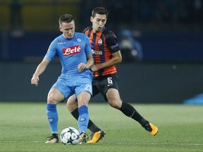 Napoli's Piotr Zielinski, left, struggles for the ball with Shakhtar's Taras Stepanenko during the Group F Champions League soccer match between Shakhtar Donetsk and Napoli at the Metalist Stadium in Kharkiv, Ukraine, Wednesday, Sept. 13, 2017. (AP Photo/Efrem Lukatsky)