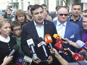 Former Georgian President and former Ukraine official, Mikheil Shaakashvili speaks to media in the south-eastern city of Przemysl, Poland, Sunday, Sept. 10, 2017, before setting off in an attempt to return to Ukraine although both his Ukrainian and Georgia passports are no longer valid. Former Prime Minister of Ukraine Yulia Tymoshenko at left. (AP Photo/Czarek Sokolowski)