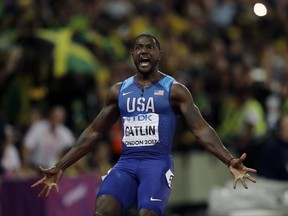 FILE - In this Aug. 5, 2017 file photo, United States' Justin Gatlin celebrates after crossing the line to win the gold medal in the men's 100m final during the World Athletics Championships in London. World sprint champion Gatlin says he won't be taking the knee in protest this weekend at an exhibition race in Brazil. Asked about it before Sunday's race, Gatlin says, "I'm going to stand up. I mean, I'm going to stand up. I'm not saying if I take the knee or stand, I'm not for the protests." (AP Photo/Tim Ireland, File)
