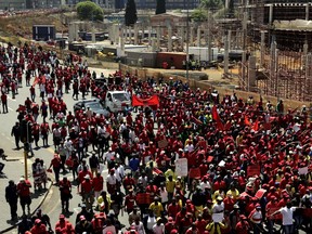 Workers march in Johannesburg, South Africa, Wednesday, Sept. 27, 2017. South Africa's biggest union group held marches nationwide on Wednesday to protest what it alleges is chronic corruption fueled by President Jacob Zuma and a prominent family of businessmen, reflecting public anger over a scandal that has ensnared several international companies. (AP Photo/Themba Hadebe)