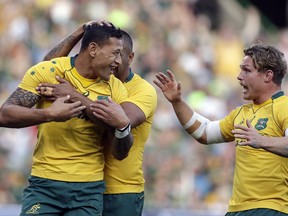 Australia's Israel Folau, left, celebrates with teammates after scoring a try during the Rugby Championship match between South Africa and Australia, at the Free State Stadium in Bloemfontein, South Africa, Saturday, Sept. 30, 2017. (AP Photo/Themba Hadebe)