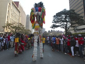 In this picture taken Saturday, September, 9, 2017, traditional Zimbabwean nyau dancers prepare to perform on the streets of Harare during the Harare International Carnival in the capital. An international carnival aimed at boosting the local tourism industry has ended in economically troubled Zimbabwe. Some viewed the Harare festivities, which ended Sunday and featured artists and dancers from Brazil, Cuba, Egypt and elsewhere, as a relief from the struggle to get by in the southern African country. (AP Photo/Tsvangirayi Mukwazhi)