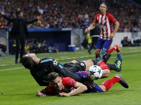 Chelsea's Alvaro Morata, left, and Atletico's Lucas fight for the ball during a Group C Champions League soccer match between Atletico Madrid and Chelsea at the Wanda Metropolitano stadium in Madrid, Spain, Wednesday Sept. 27, 2017. (AP Photo/Paul White)