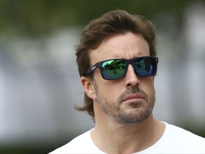 McLaren driver Fernando Alonso of Spain arrives at Sepang International Circuit ahead of the Malaysian Formula One Grand Prix in Sepang, Malaysia, Thursday, Sept. 28, 2017. (AP Photo/Vincent Phoon)