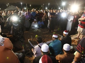 Muslims prays during a mass funeral for victims of a school fire outside of Kuala Lumpur, Malaysia on Friday, Sept. 15, 2017. Officials said the private Islamic boarding school was operating without a fire safety permit and license, and that a dividing wall was illegally built on the top floor that blocked the victims from a second exit. (AP Photo/Daniel Chan)