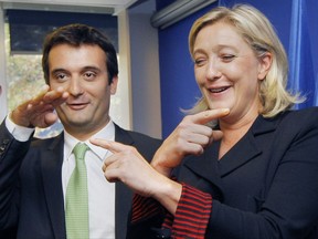 FILE - In this Oct. 6, 2011 file photo, French far-right Front National party leader Marine Le Pen and her director for strategy Florian Philippot gesture during a presentation of the Front National Staff for the presidential campaign's election in Nanterre near Paris. The far-right National Front is at it again, feuding. Tensions since Marine Le Pen's loss in the May presidential race are going public with the firing of a regional leader and friend of Le Pen's top lieutenant who some claim is no longer loyal. (AP Photo/Jacques Brinon, File)