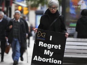 A protestor walks in front of an abortion clinic in downtown Ottawa, Ontario, September 26, 2012.