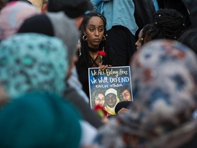 People hold up signs during a vigil  in Washington, DC, on June 20, 2017, for slain Muslim teen Nabra Hassanen, 17.