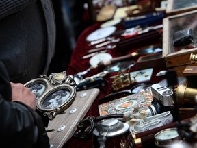 A woman checks out a picture frame at the flea market in the Vohwinkel district near the city of Wuppertal, western Germany.