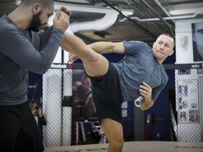 Georges St-Pierre spars with his head trainer, Firaz Zahabi, at Tristar Gym in Montreal on Wednesday in preparation for his comeback fight Nov. 4 against Michael Bisping at Madison Square Garden.