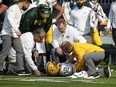 Green Bay Packers quarterback Aaron Rodgers is attended to by medical staff after being hit by Minnesota Vikings linebacker Anthony Barr in the first half of Sunday's game in Minneapolis.