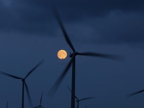 The moon rises behind the turbines of Whitelees Windfarm on October 7, 2014 in Glasgow, Scotland.