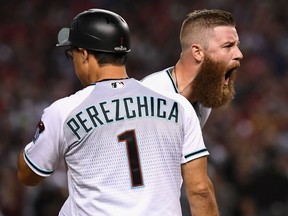 Archie Bradley of the Arizona Diamondbacks shouts after hitting an RBI triple during the bottom of the seventh inning of the National League wild card game against the Colorado Rockies at Chase Field in Phoenix on Wednesday night.