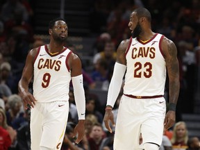 Back together again: Dwyane Wade talks with LeBron James during a pre-season game at Quicken Loans Arena on Oct. 10, 2017 in Cleveland.