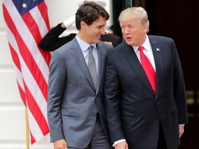 U.S. President Donald Trump and Prime Minister Justin Trudeau pose for photographs after Trudeau's arrival at the White House October 11, 2017 in Washington, DC.