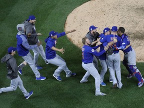 The Chicago Cubs celebrate defeating the Washington Nationals 9-8 in Game 5 of the National League Division Series at Nationals Park on Oct. 13, 2017