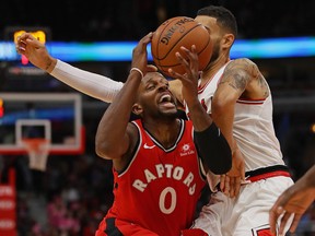 C.J. Miles of the Toronto Raptors tries to drive against Denzel Valentine of the Chicago Bulls during a preseason game at the United Center on Oct. 13, 2017.