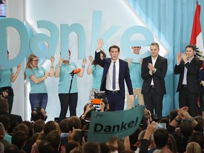 Sebastian Kurz (C), Austrian Foreign Minister and leader of the conservative Austrian People's Party (OeVP), greets supporters after initial results give the party a first place finish and 31.4% of the vote in Austrian parliamentary elections on October 15, 2017 in Vienna, Austria.