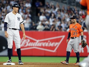 New York Yankees right fielder Aaron Judge (left) stands near Houston Astros second baseman Jose Altuve on Oct. 18.