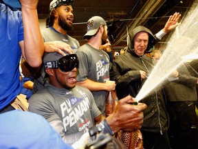 Los Angeles Dodgers outfielder Yasiel Puig sprays Champagne on Oct. 19.