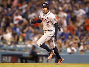 George Springer of the Houston Astros celebrates after hitting a two-run homer during the 11th inning against the Dodgers in Game 2 World Series at Dodger Stadium on in Los Angeles on Wednesday night.