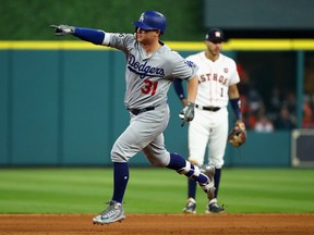 Joc Pederson of the Los Angeles Dodgers celebrates as he rounds the bases after hitting a three-run homer during the ninth inning against the Astros in Game 4 of the World Series at Minute Maid Park in Houston on Saturday night.