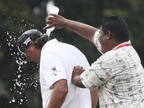 Pat Perez is splashed with a bottle of water on 18th hole after winning the CIMB Classic golf tournament at Tournament Players Club in Kuala Lumpur, Malaysia, Sunday, Oct. 15, 2017.