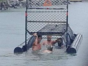 An investigation was launched after photos of four men swimming into a crocodile trap in Australia surfaced online.