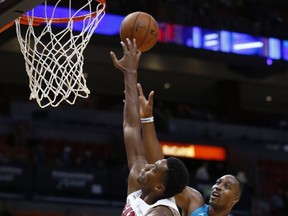 Miami Heat center Hassan Whiteside (21) blocks a shot from Charlotte Hornets center Dwight Howard (12) during the first half of an NBA preseason basketball game, Monday, Oct. 9, 2017, in Miami. (AP Photo/Wilfredo Lee)