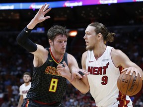 Miami Heat forward Kelly Olynyk (9) drives past Atlanta Hawks forward Luke Babbitt (8) during the first half of an NBA basketball game Monday, Oct. 23, 2017, in Miami. (AP Photo/Wilfredo Lee)