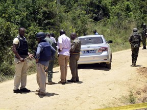 Armed security officers at the scene of shooting in Ukunda town, south coast of Mombasa, Kenya Tuesday, Oct. 10, 2017. Gunmen killed two employees of a technical university in Kwale, near Mombasa on Kenya's Indian Ocean coast in a suspected extremist attack, a Kenyan police official said Tuesday. The assault occurred as President Uhuru Kenyatta campaigned in the coastal region for fresh presidential elections later this month. (AP Photo)