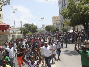 Angry protesters march near the scene of Saturday's massive truck bomb attack in which over 300 people were killed in Mogadishu, Somalia, Wednesday, Oct. 18, 2017. Thousands of people took to the streets of Somalia's capital Wednesday in a show of defiance after the country's deadliest attack, as two people were arrested in connection with Saturday's massive truck bombing that killed more than 300. (AP Photo/Farah Abdi Warsameh)