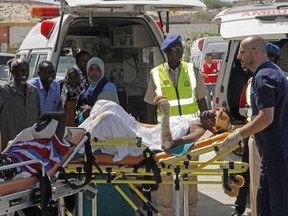 Turkish doctors transport a critically wounded man on a stretcher to a waiting Turkish air ambulance to airlift injured patients for treatment in Turkey, in Mogadishu, Somalia, Monday, Oct,16, 2017. The death toll from Saturday's truck bombing in Somalia's capital now exceeds 300, the director of an ambulance service said Monday, as the country reeled from the deadliest single attack. (AP Photo/Farah Abdi Warsameh)