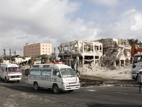 Ambulances carrying wounded victims passes the scene of Saturday's truck bomb blast, as they head to airport to be airlifted by Turkish air ambulance for treatment in Turkey, in Mogadishu, Somalia, Monday, Oct, 16, 2017. The death toll from Saturday's truck bombing in Somalia's capital now exceeds 300, the director of an ambulance service said Monday, as the country reeled from the deadliest single attack. (AP Photo/Farah Abdi Warsameh)