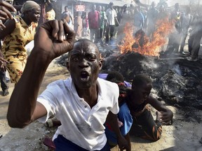 A opposition supporter reacts after burning tyres during demonstrations in Mombasa, Kenya, Thursday, Oct. 26, 2017. Kenya is holding the rerun of its disputed presidential election Thursday, despite a boycott by the main opposition party and rising political tensions in the East African country. (AP Photo)